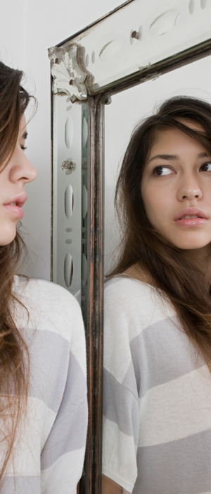 woman looking in a mirror